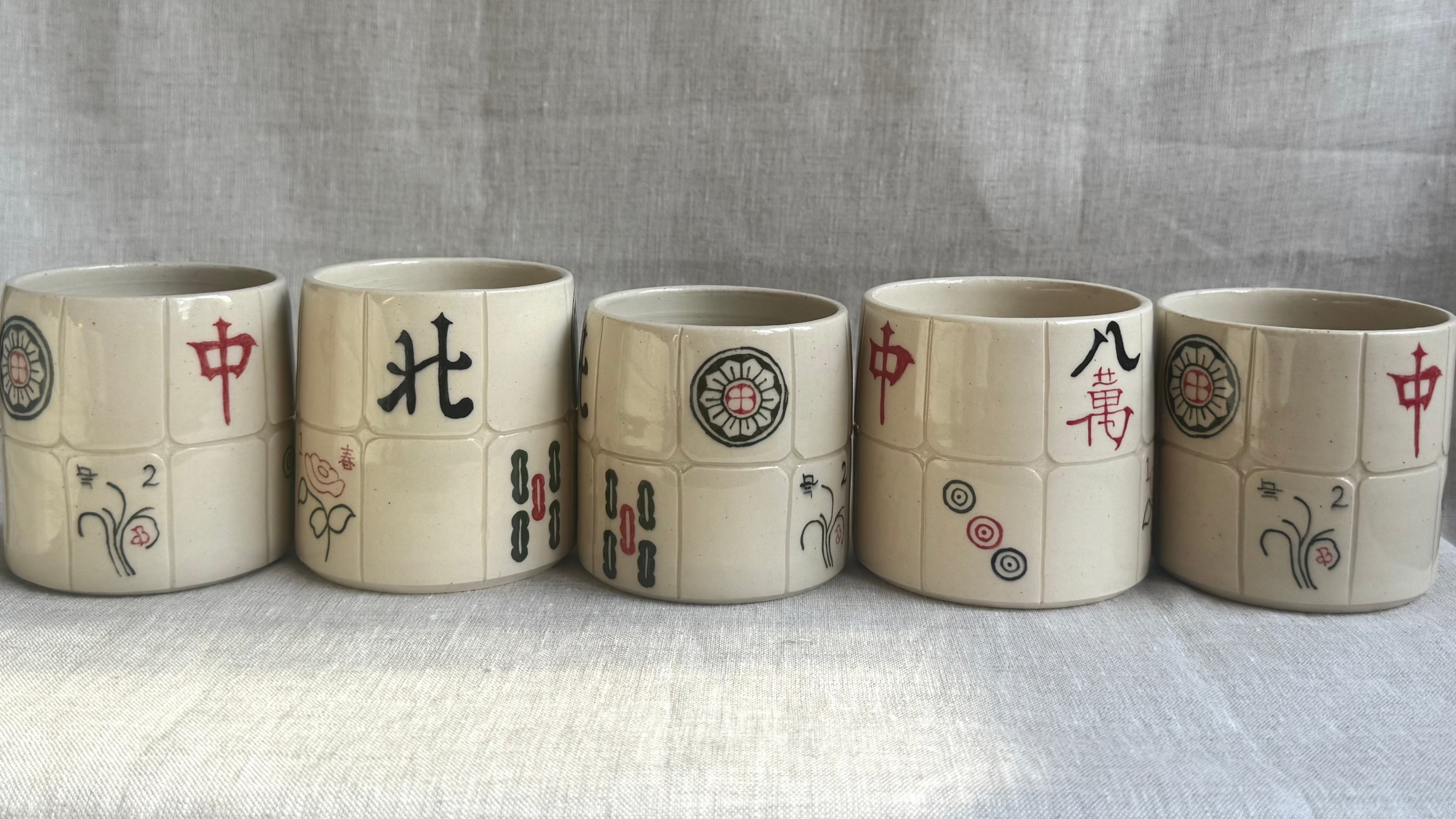 Five ceramic mahjong tile cups